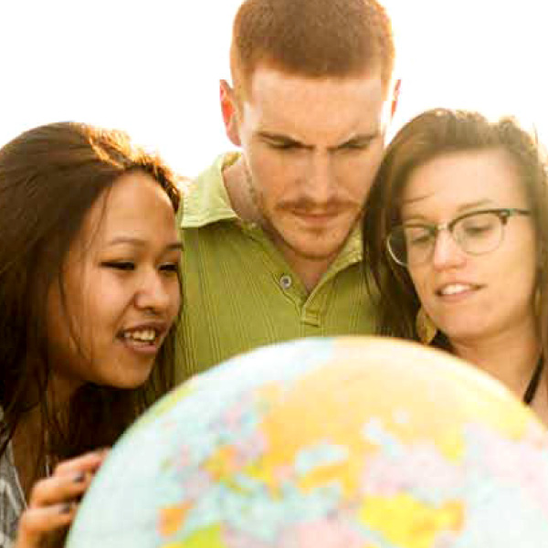 group of people around a globe