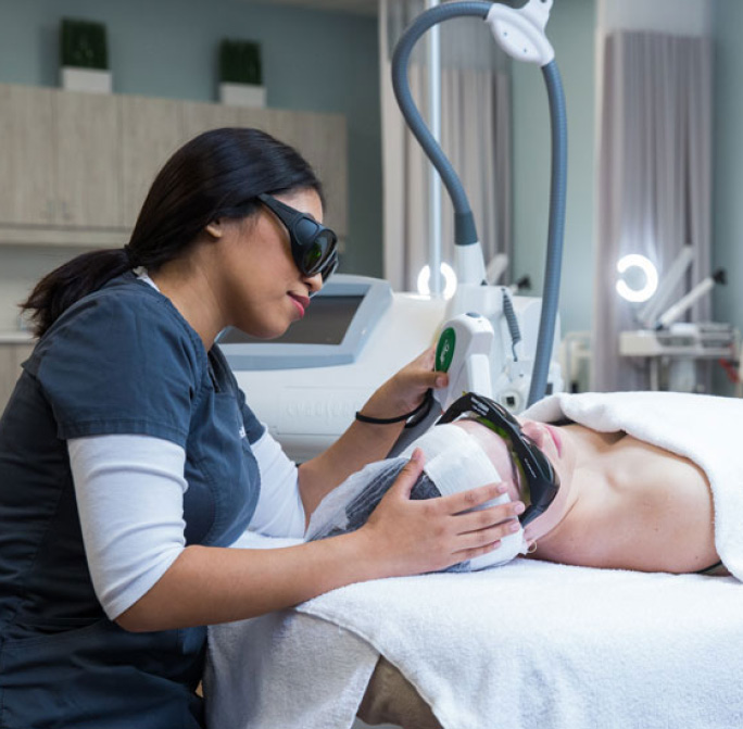 esthetician student using facial technology