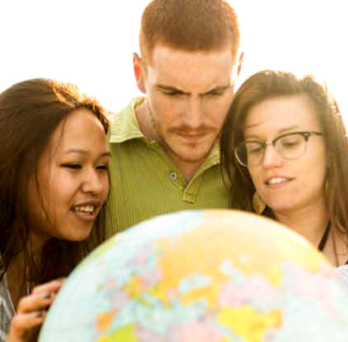 group of people looking at a globe