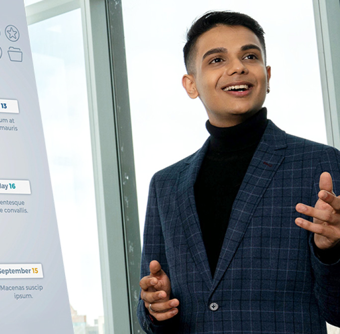 student in a suit presenting