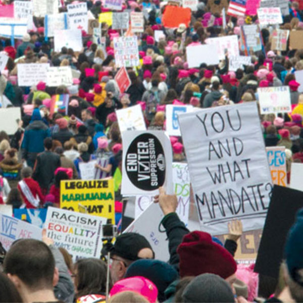 large group protest with people holding signs