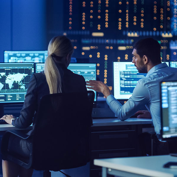 Man and woman working on computers