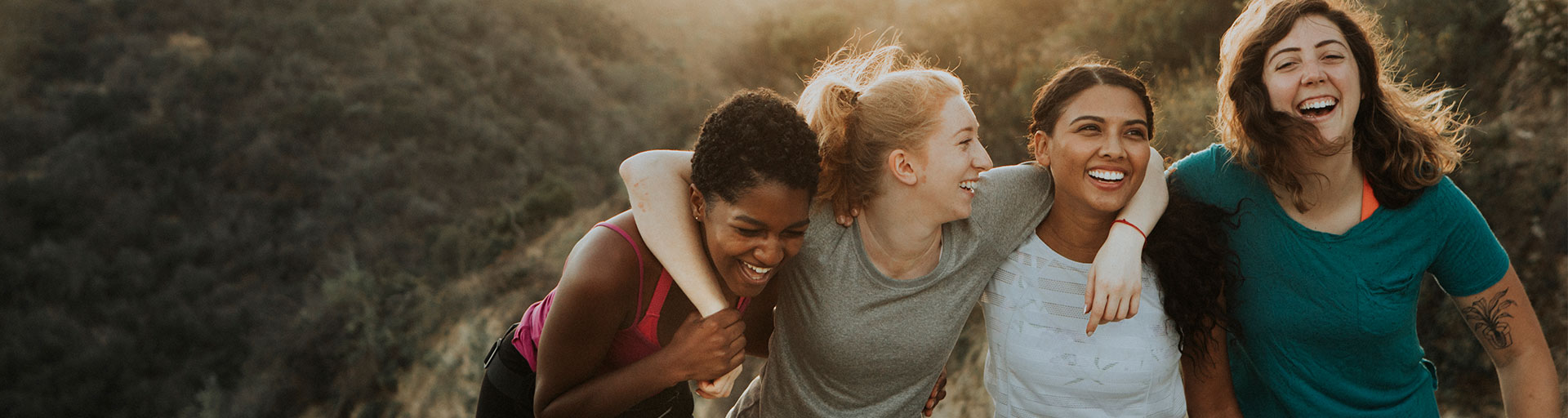 group of girls laughing while hiking