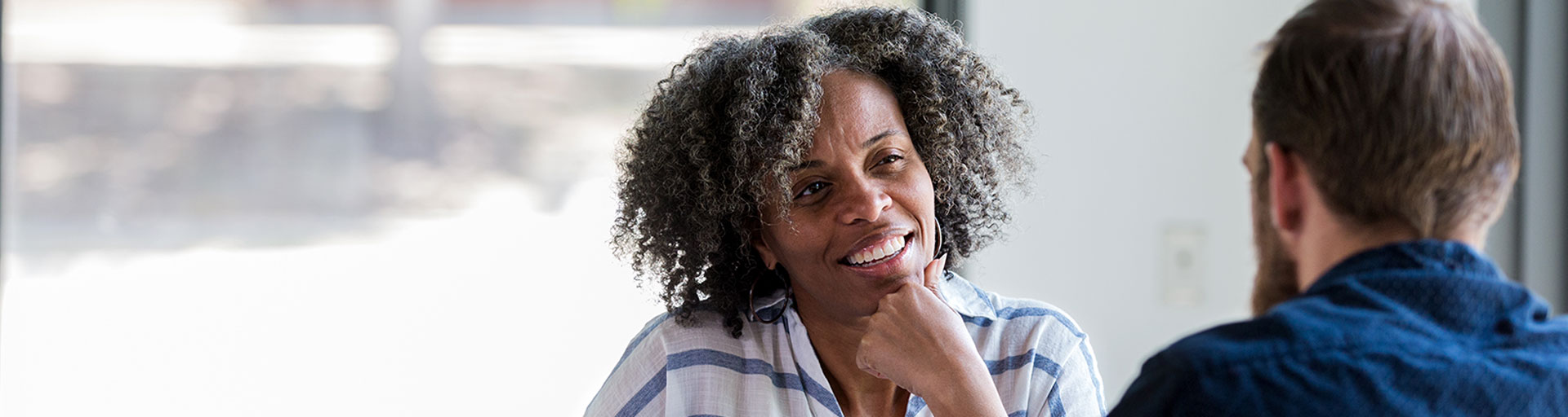 Mature woman smiling during career consultation.