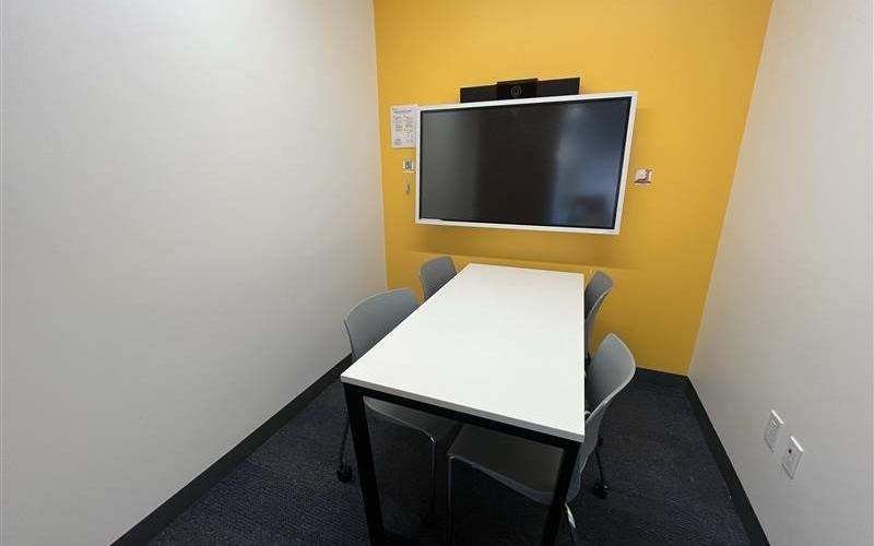 Small meeting room with table, chairs & screen
