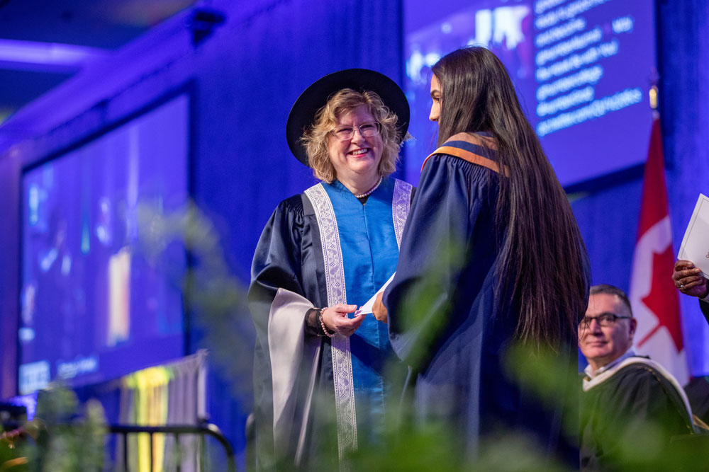 Ann Marie Vaughn presenting award to graduate