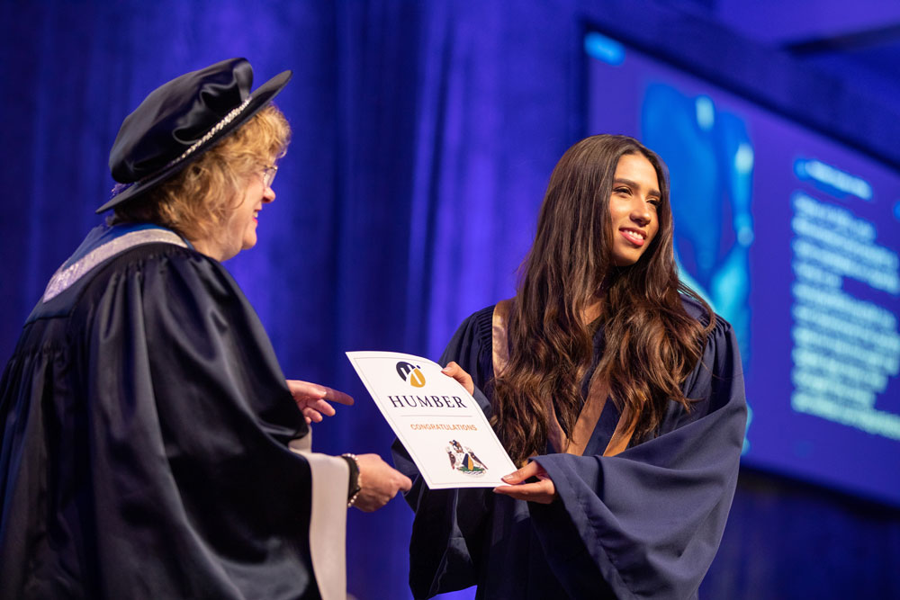 Graduate receiving certificate from Humber president
