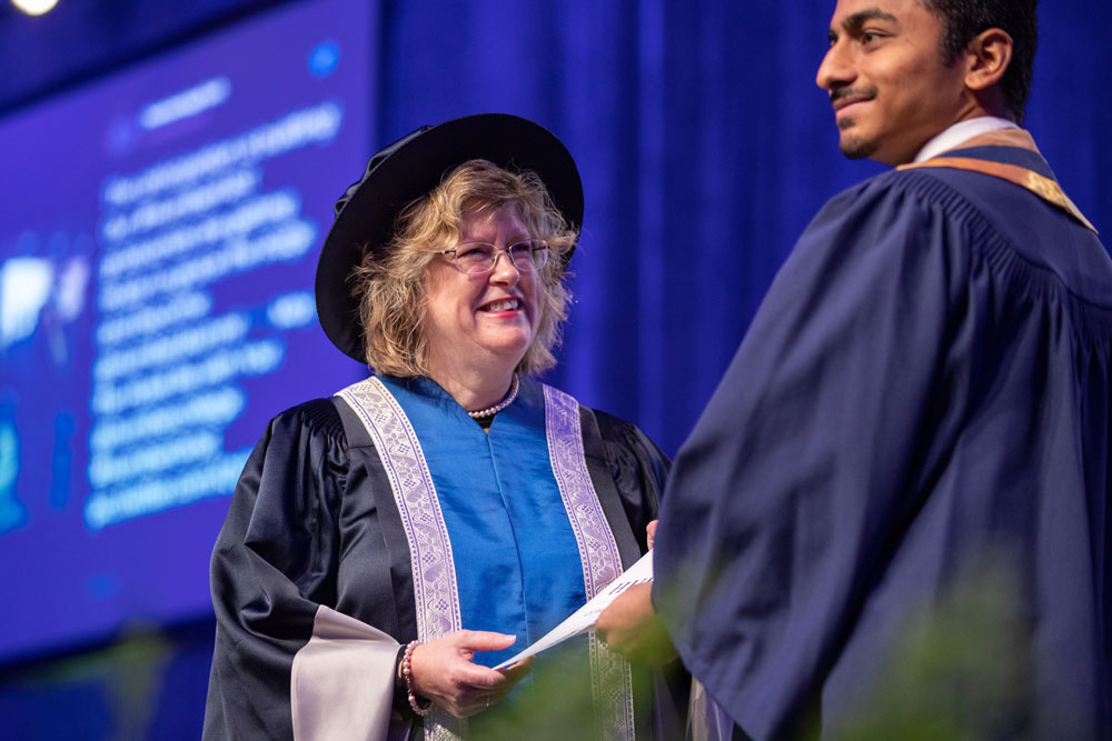 Humber president smiling and presenting certificate