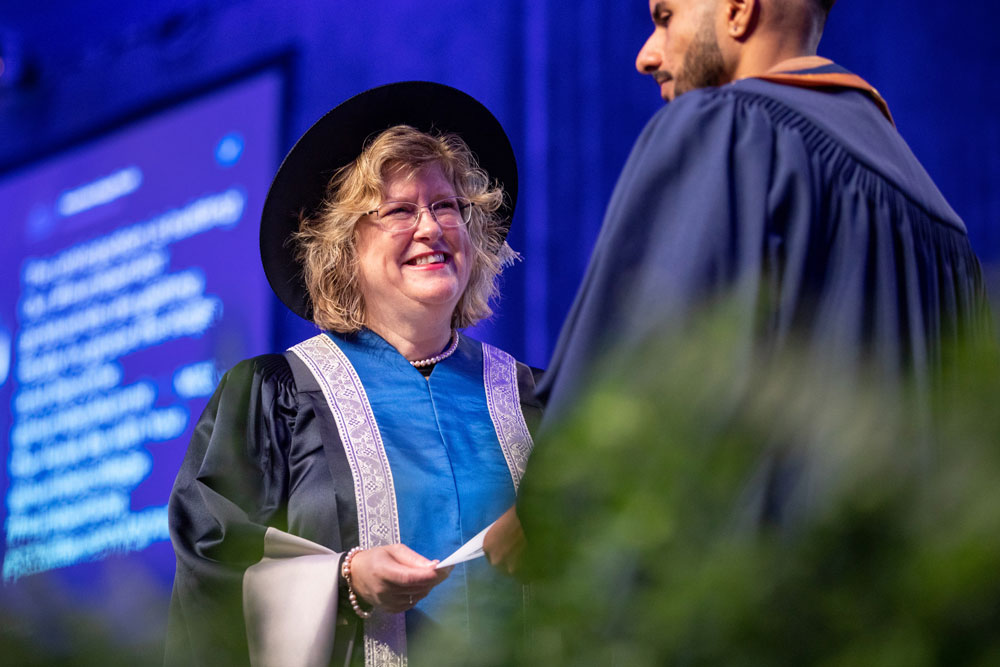 Humber president smiling and presenting certificate