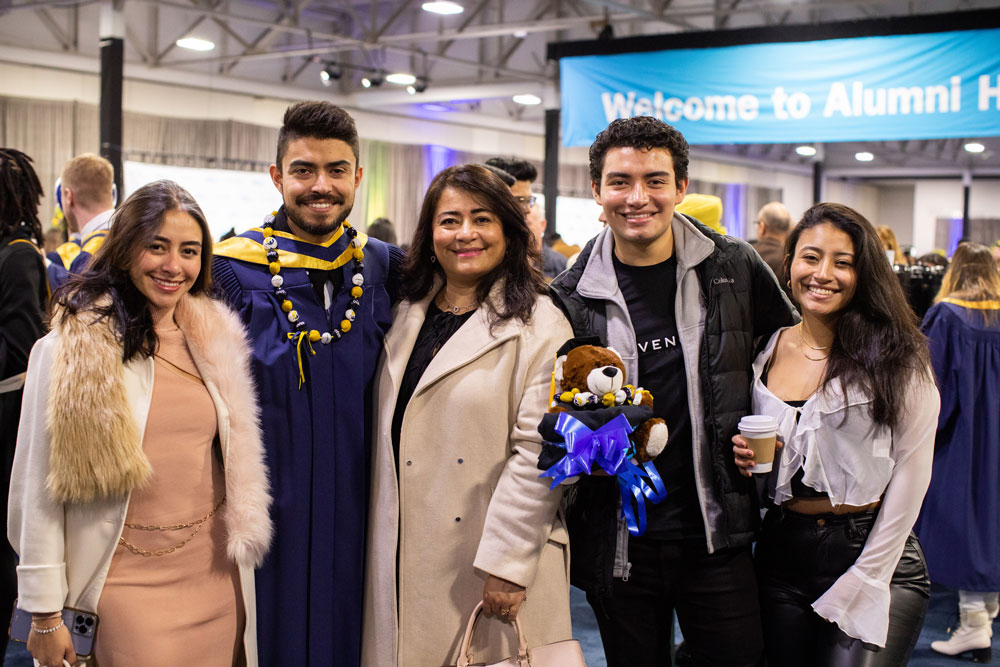 Grad posing with people for photo