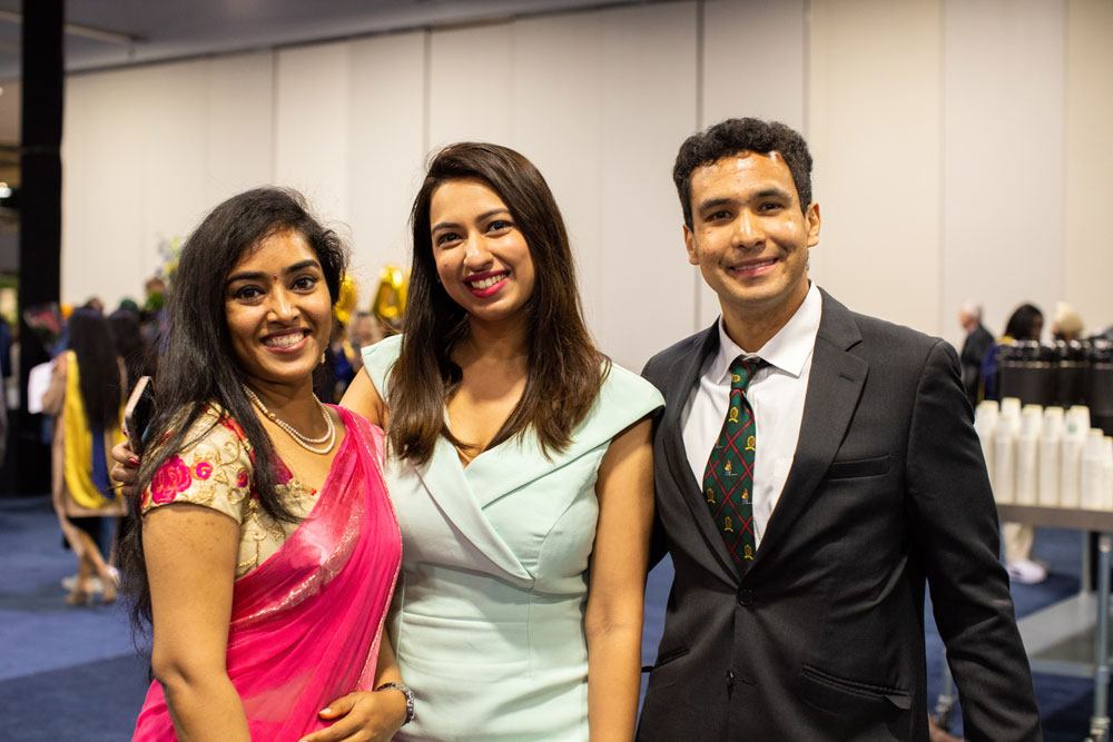 Three people smiling for photo