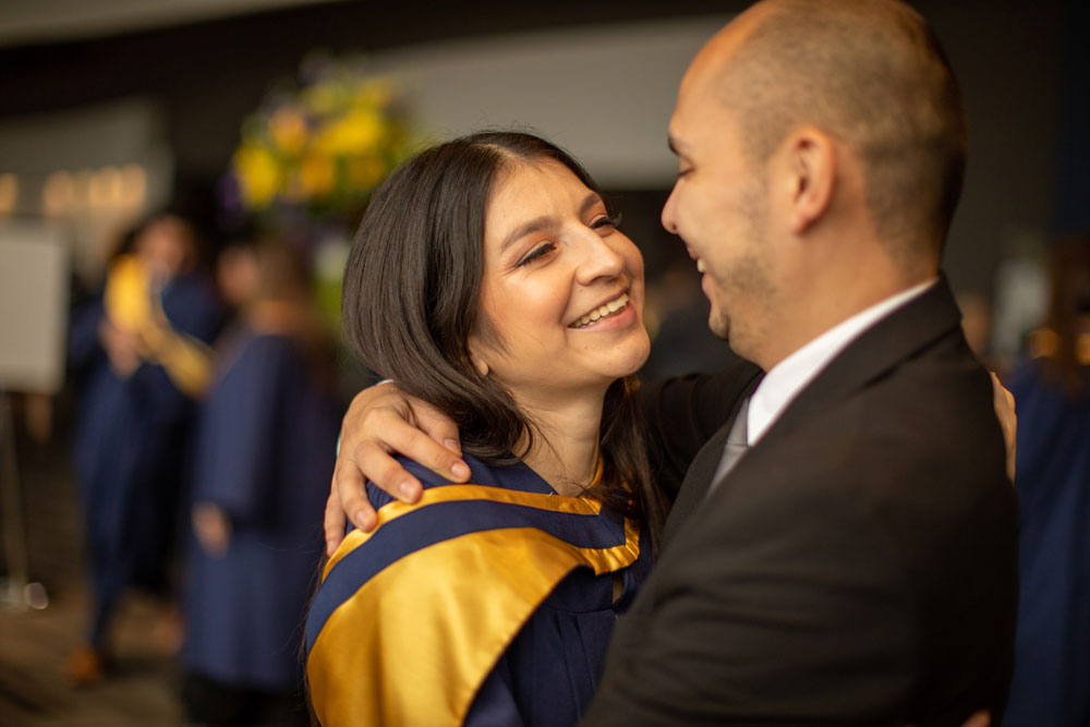 Grad hugging person