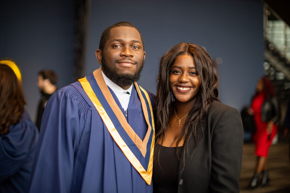 Grad posing with another person