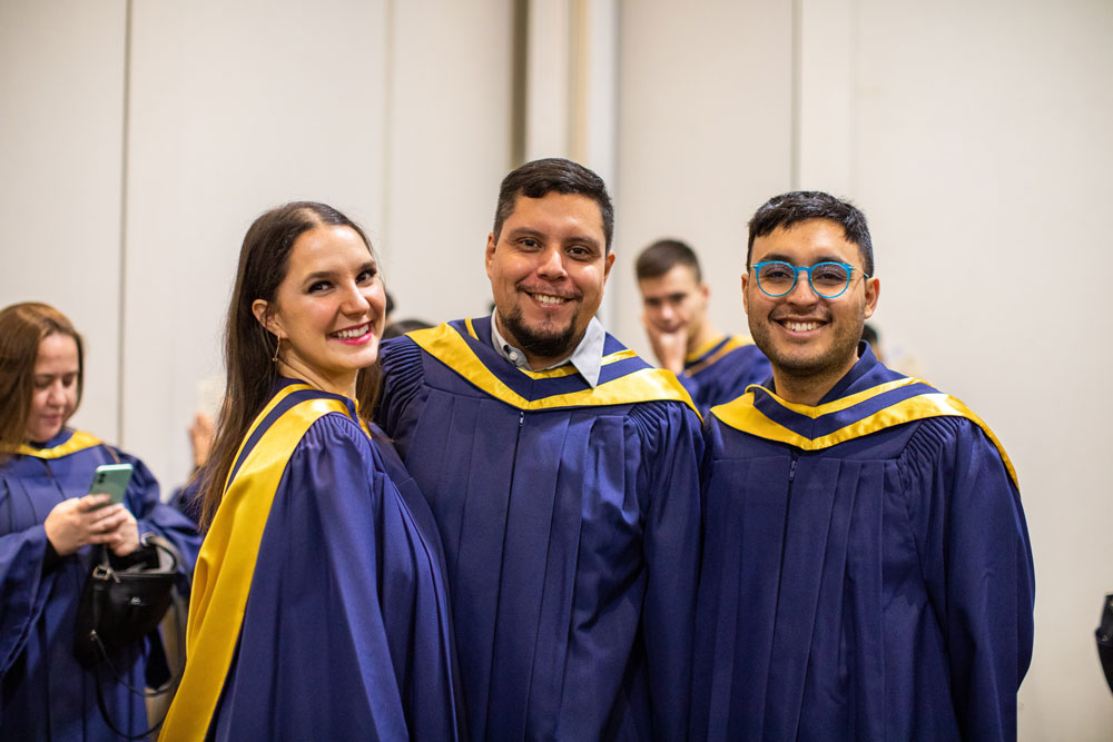Three grads smiling for camera