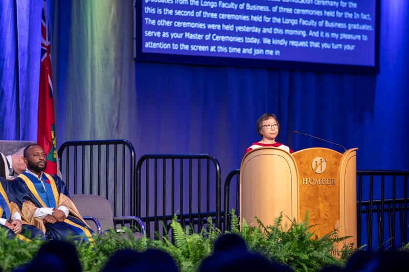 Person behind podium on ceremony stage