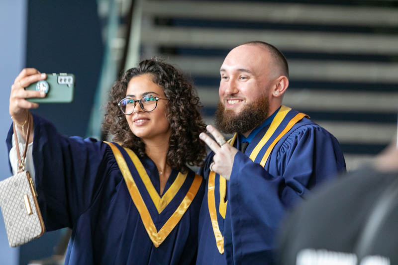 Two graduates taking a selfie together