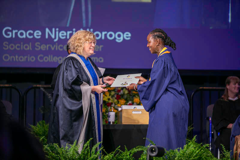 Graduate accepts certificate on stage