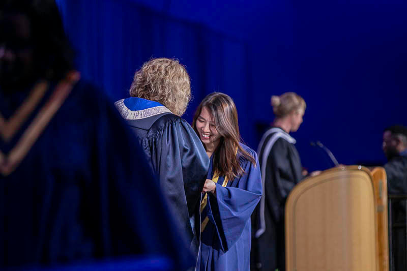 Graduate on stage with Ann Marie Vaughan
