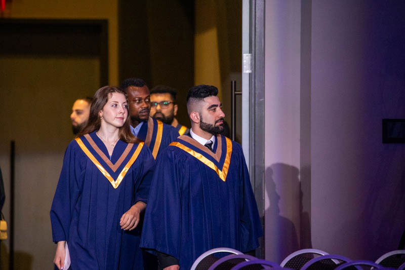 Graduates enter the ceremony hall