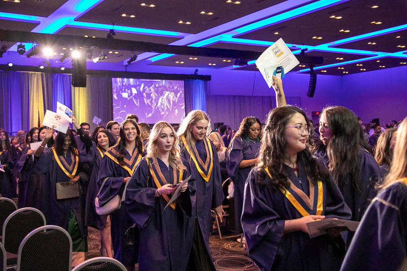Graduates proceed out of ceremony hall