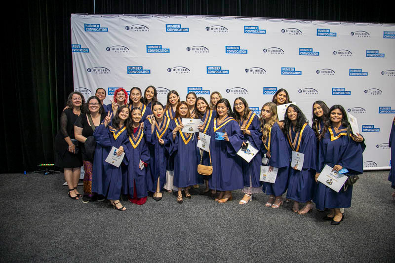 Large group of graduates pose for camera