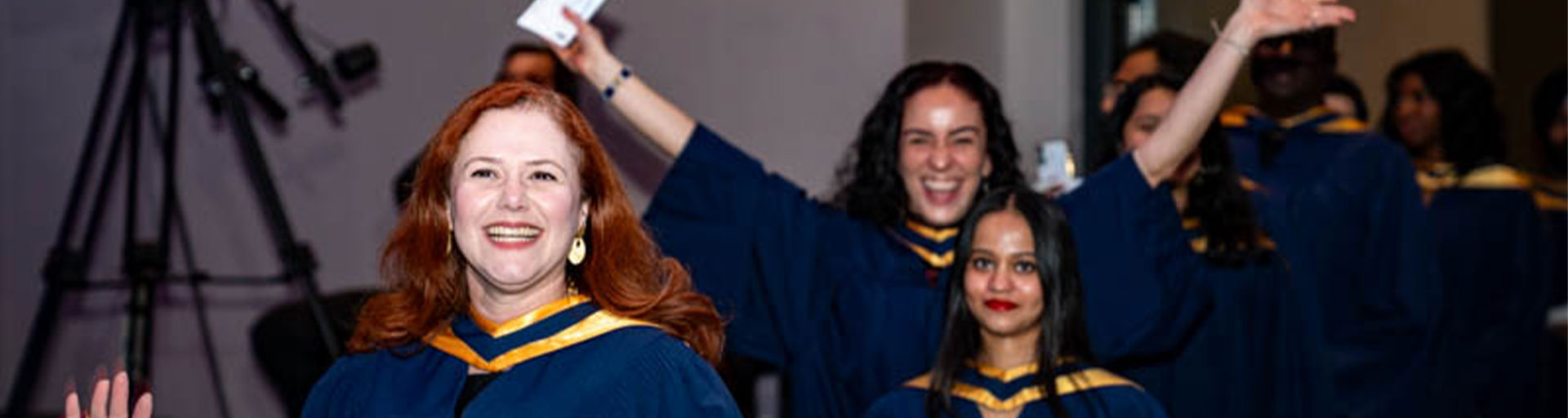 Graduates smiling in line