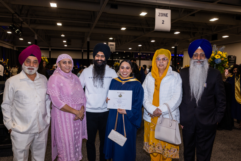 Student and family posing with diploma