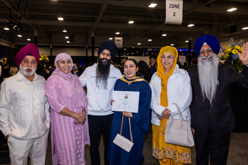 Student and family posing with diploma