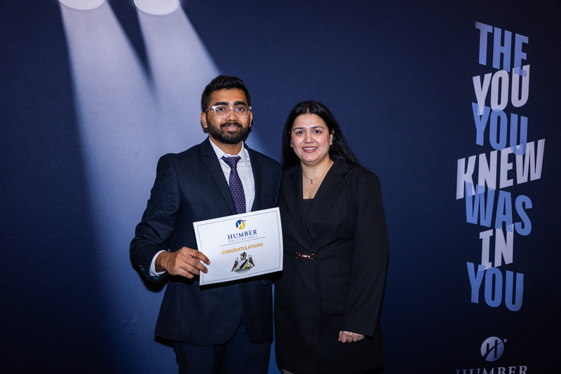Student posing with diploma