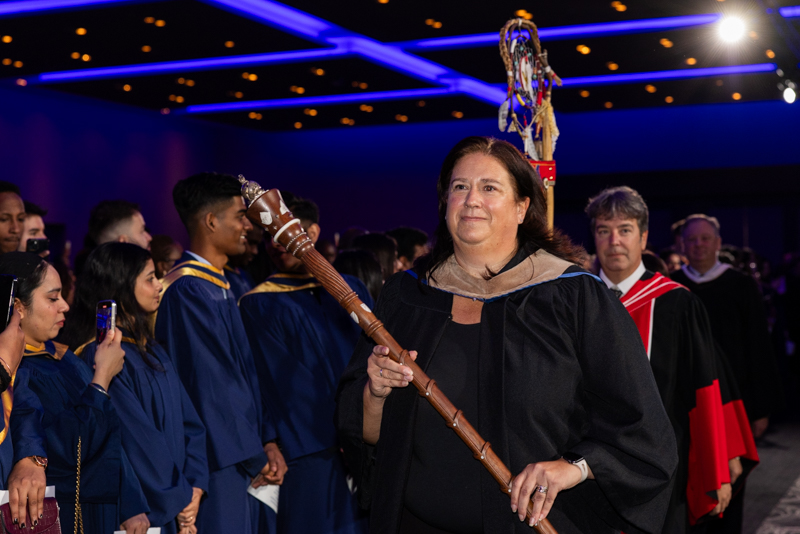 Person carrying wood staff