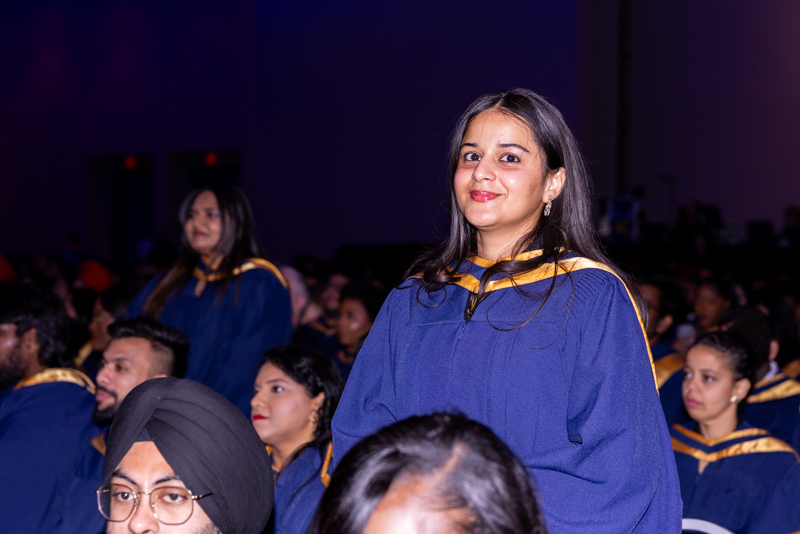 Students standing up and smiling