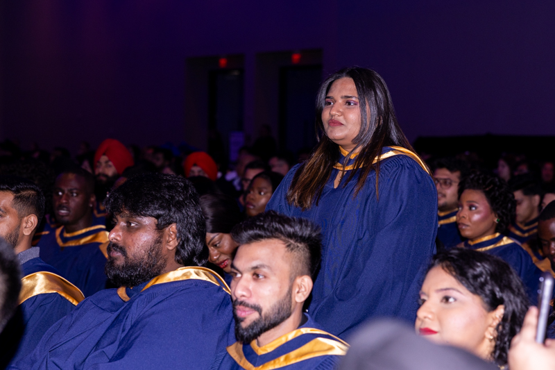 Students standing up and smiling