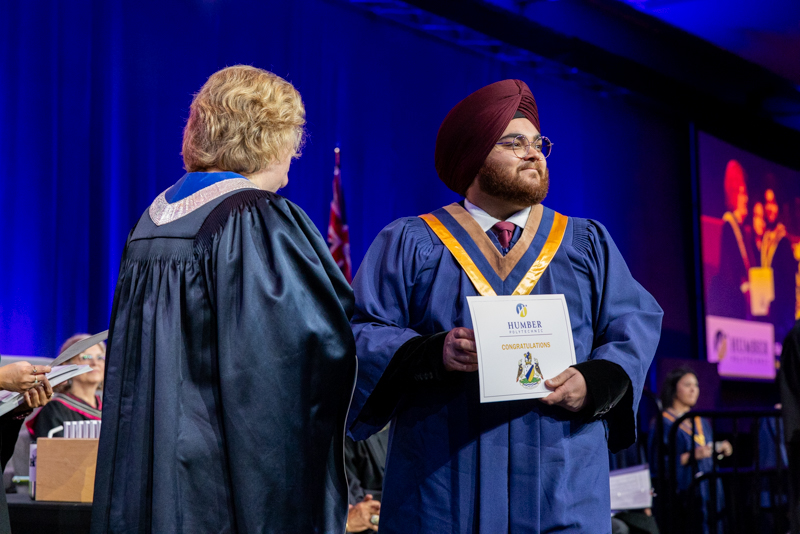 Student posing with diploma