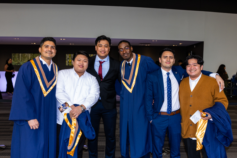 Students posing in gown