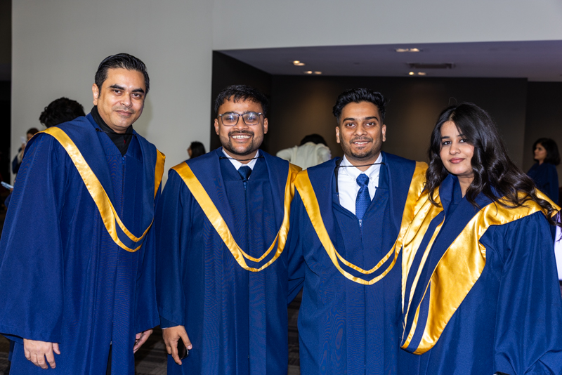 Students posing in gown