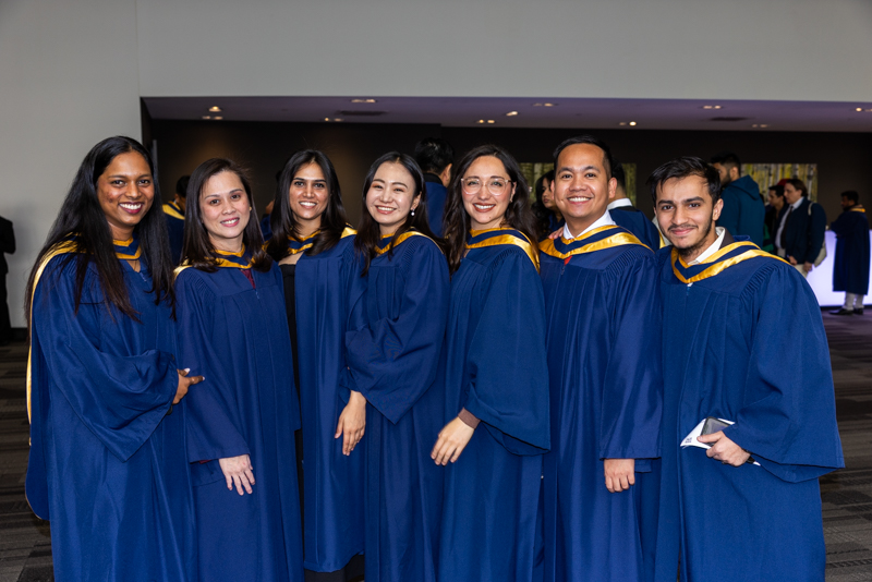 Students posing in gown