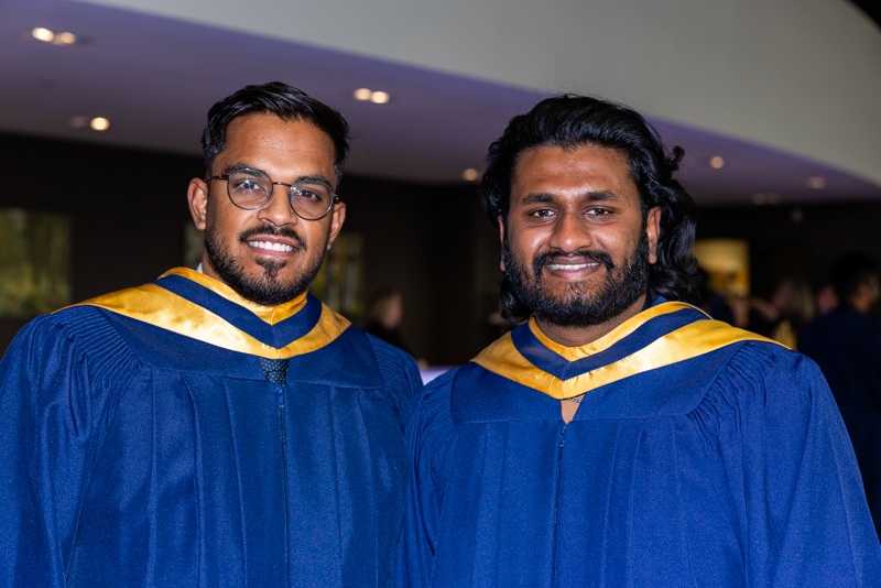 Two Students posing in gown