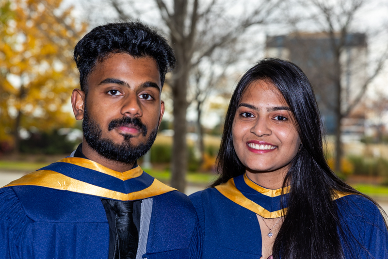 Two Students posing in gown