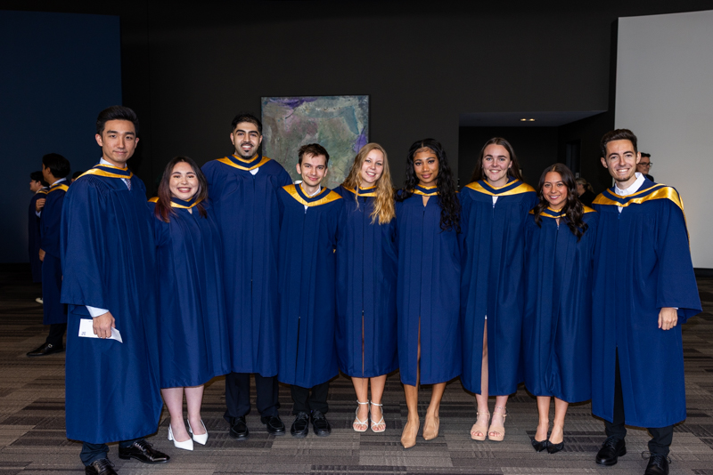 Students posing in gown