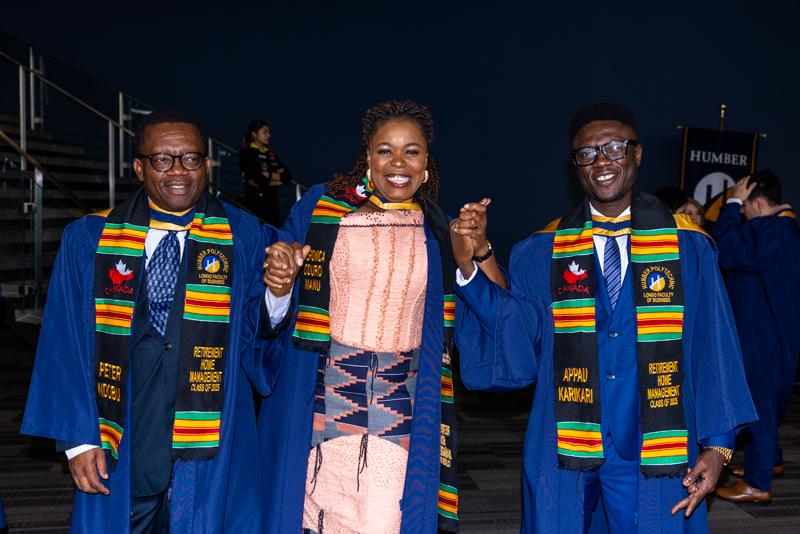 Students posing in gown