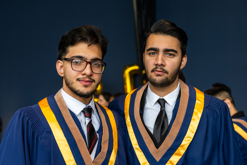 Two Students posing in gown