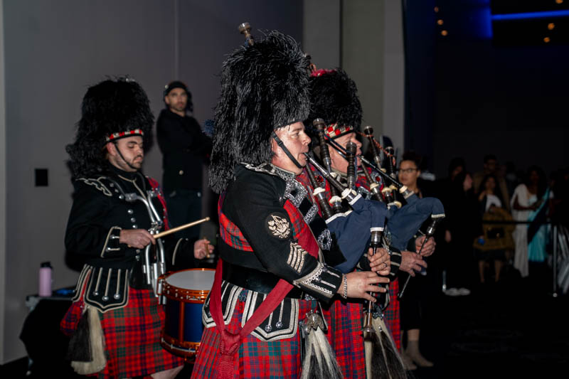 People in kilts playing bagpipes