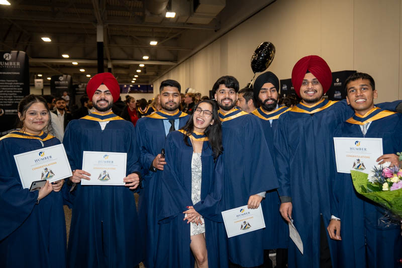 Students posing with diplomas