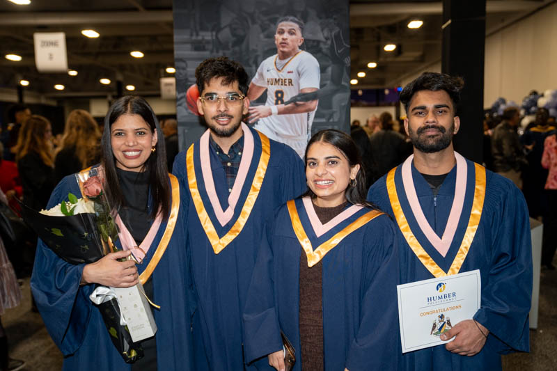 Students posing with diplomas