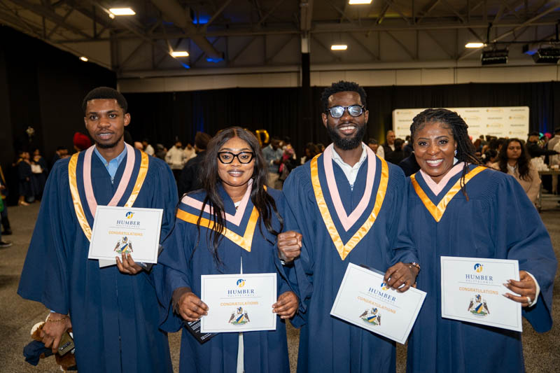 Students posing with diplomas