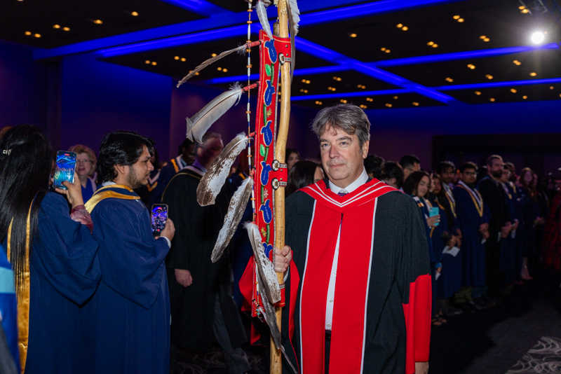 Humber staff hoding Indigenous staff