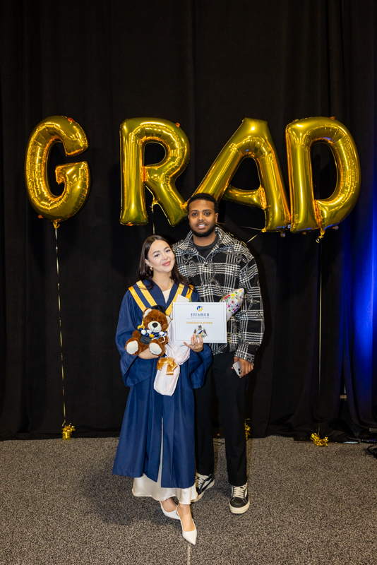 Students in front of Grad Balloons