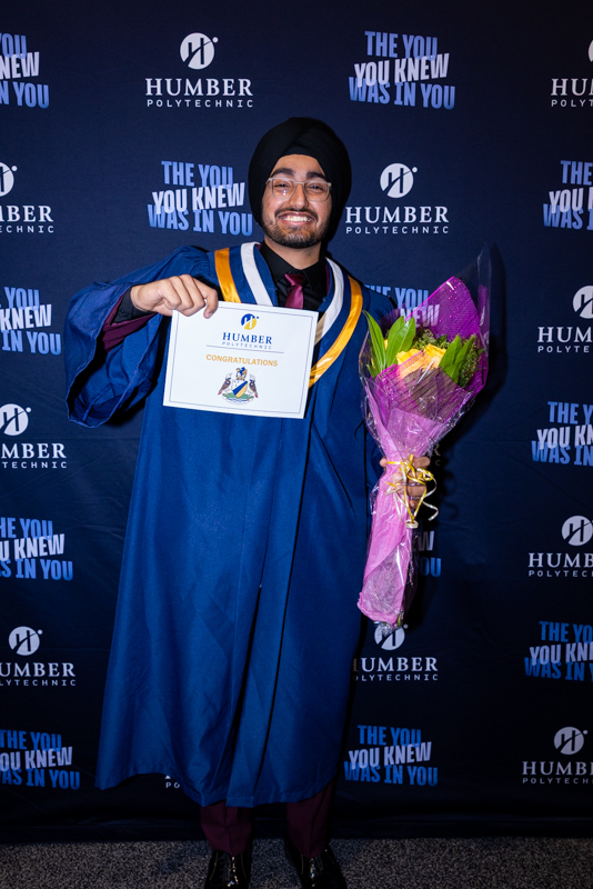 Student holding flowers and diploma