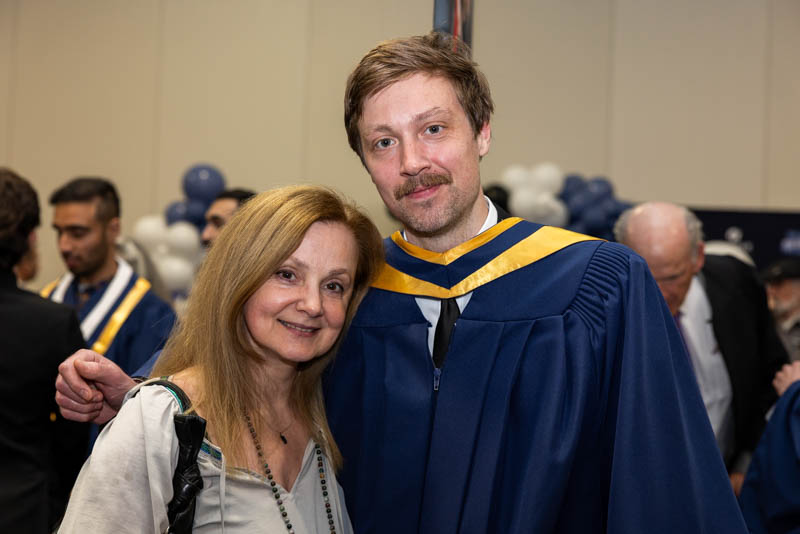 Humber graduate standing with family