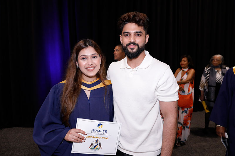 People posing with certificate